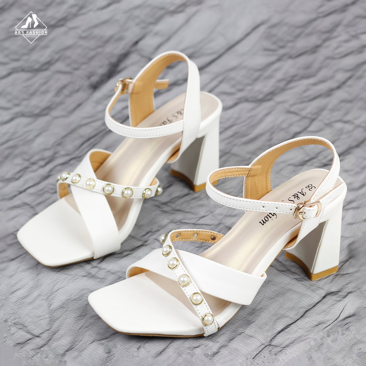 There are small pearl embellishments on the straps.