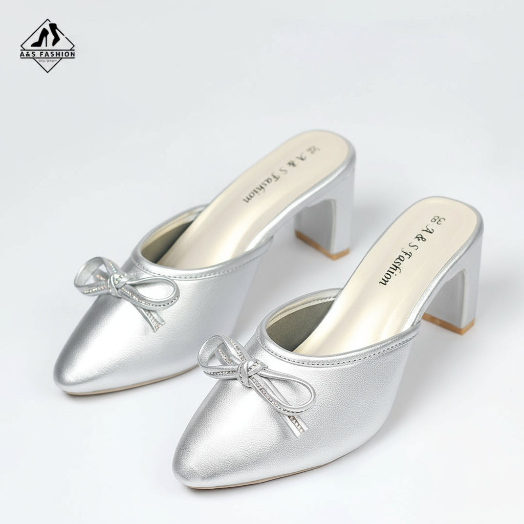 Silver high-heeled shoes with bow details on a white background