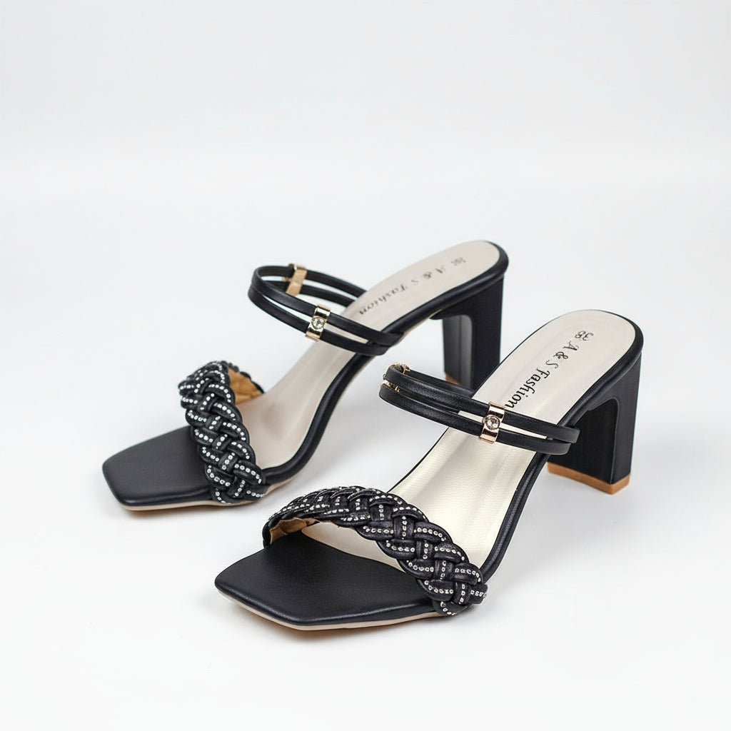 Black high-heeled sandals with braided straps on a white background