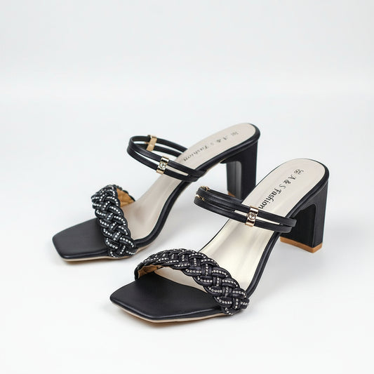 Black high-heeled sandals with braided straps on a white background